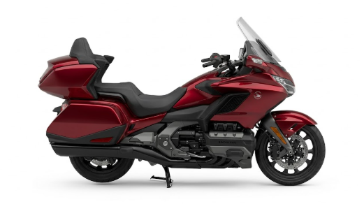 Moto honda gold wing noire stationnée sur route avec valises intégrées et équipement grand tourisme.