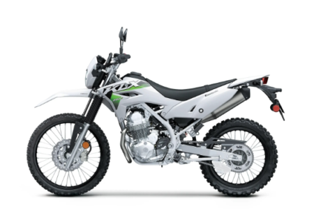Moto kawasaki klx 230 verte stationnée sur un chemin tout-terrain avec suspension renforcée et pneus off-road.