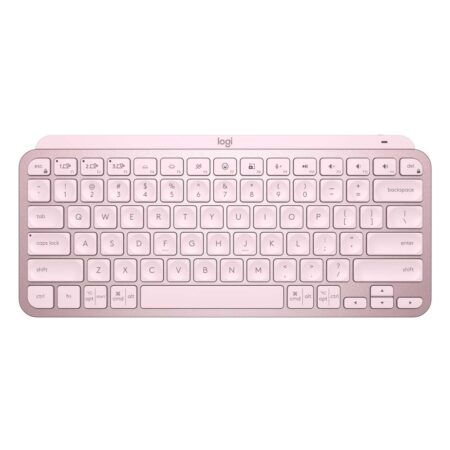 Clavier compact sans fil rose poudré clavier logitech mx keys mini rose sur un bureau blanc.